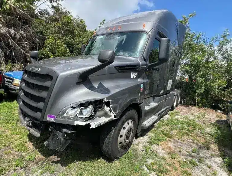 Semi-truck with front-end collision damage before auto body repair